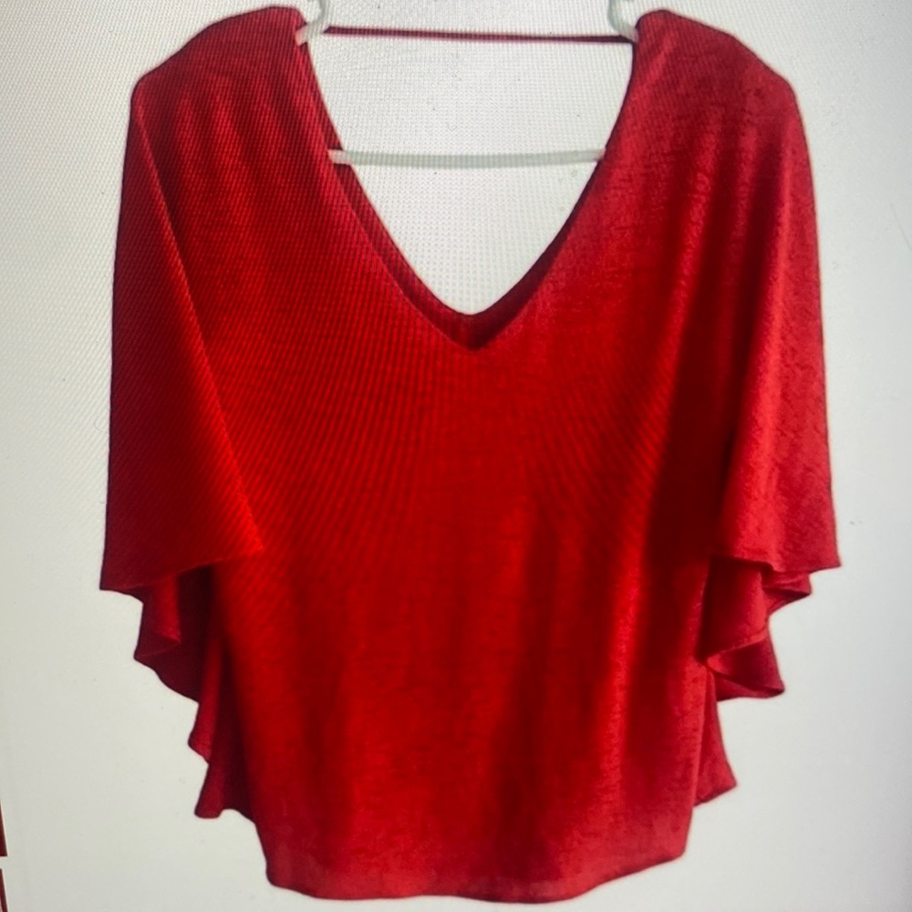 Carrie’s red v-neck butterfly sleeve top